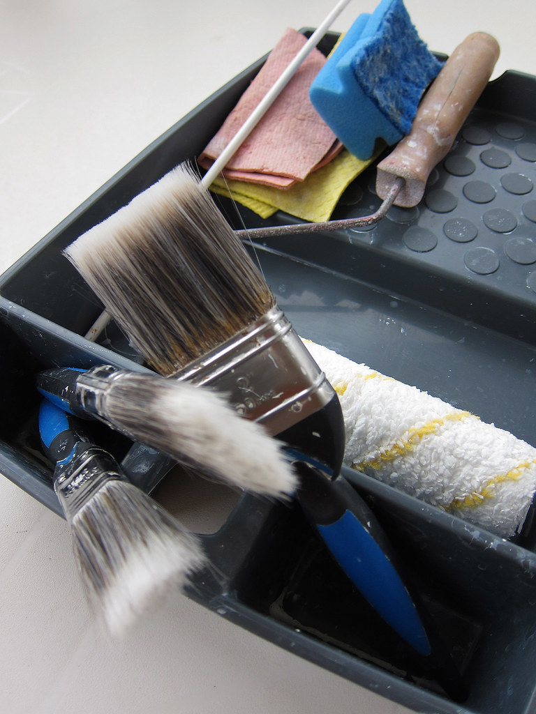 A painter's brushes and roller ready for a job